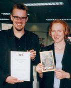 Clive and Hodder’s Anne Clark pose with
the TES Information Book of the Year award.